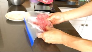 Crush freeze dried strawberries in a ziploc bag