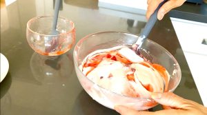 Fold strawberry sauce into coconut ice cream