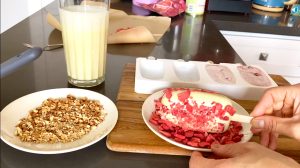 Sprinkle popsicles with freeze dried strawberries and nuts