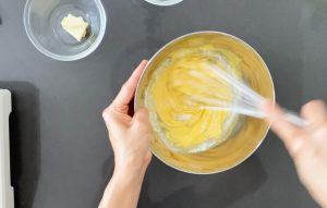 Adding flour to the egg mixture