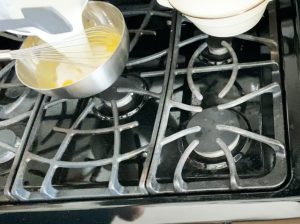 Adding milk into the custard mixture