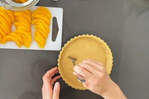 Pricking the tart shell with a folk