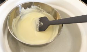Melt white chocolate in a double boiler
