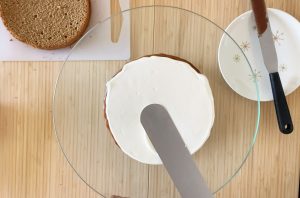 Spread butter cream on the 2nd coffee sponge cake
