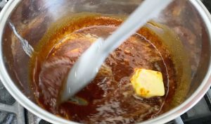 Add unsalted butter to cooked caramel