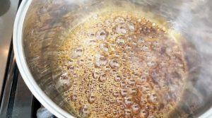 Cook water and sugar until it becomes amber color