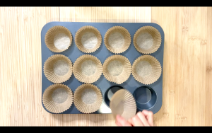 Line muffin tin with papercups