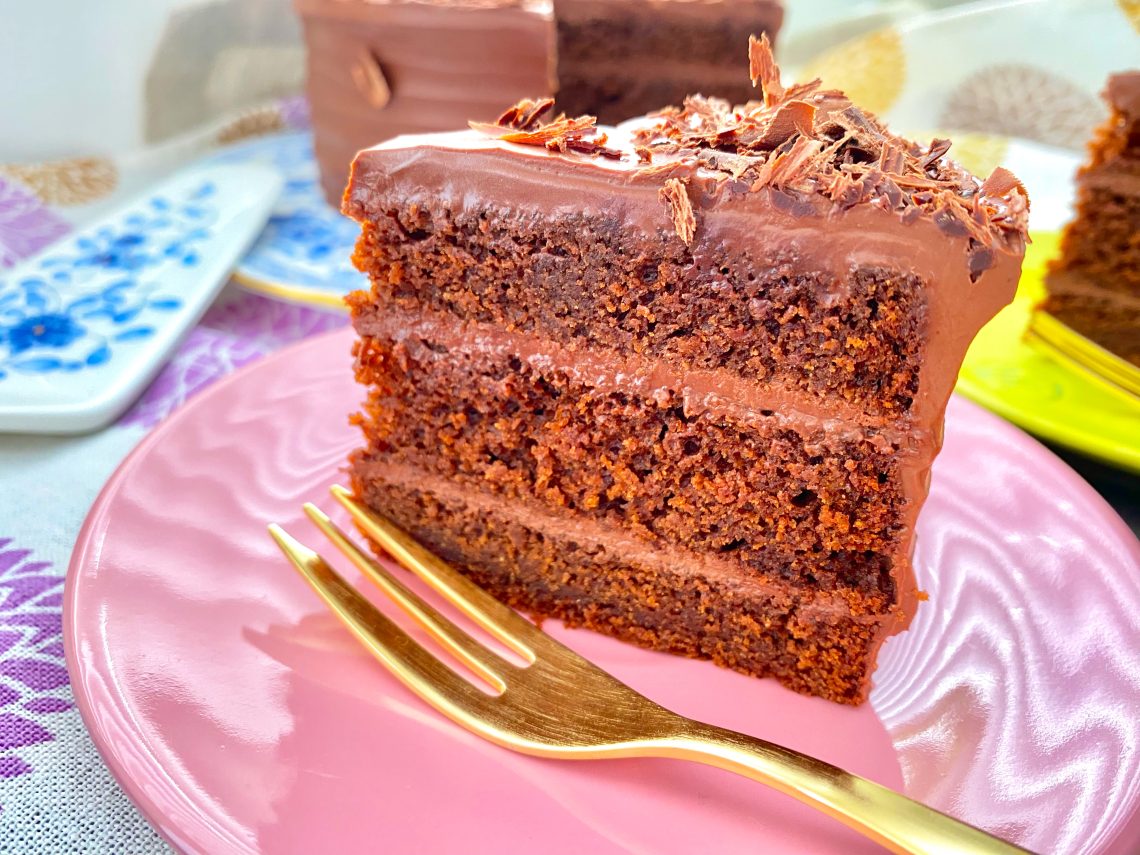 Vegan double chocolate ganache cake with olive oil on a pink plate