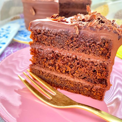 Vegan double chocolate ganache cake with olive oil on a pink plate
