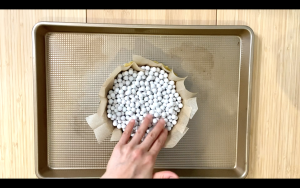 Place parchment paper and pie weights