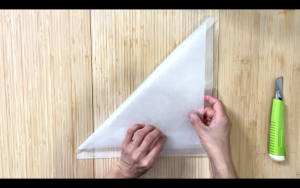 Cut parchment paper into 2 triangles